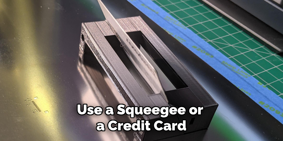 Use a Squeegee or a Credit Card